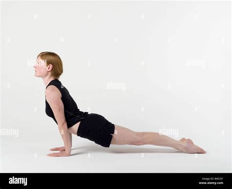 A Young Woman Practicing The Upward Facing Dog Yoga Pose Stock Photo
