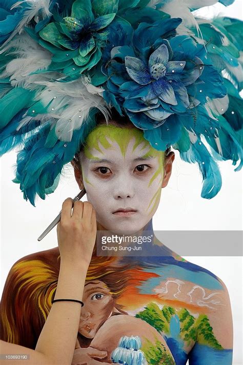 An Artist Paints A Model During The Daegu International Bodypainting Festival On August