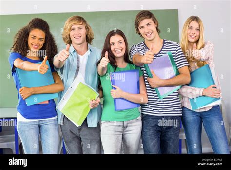 Happy College Students Gesturing Thumbs Up Stock Photo Alamy