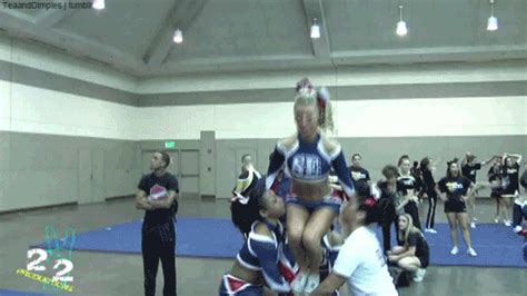 The Cheerleaders Are Doing Stunts In The Gym