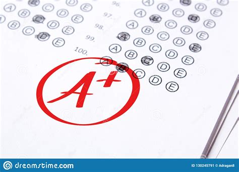 Good Grade Of A Plus Is Written With Red Pen On The Tests Stock Image