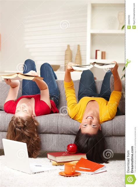 Girls Smiling Upside Down On Sofa Stock Image Image Of Happiness