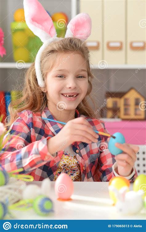 Close Up Portrait Of Happy Girl Painting Eggs For Easter Holiday Stock