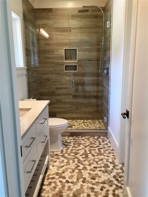 Table of contents pebbled floor shower is today in demand a pebble shower floor can be a diy matter Pebbles on floor and wood-look porcelain plank tile on ...