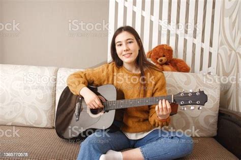 Beautiful Asian Brunette Young Woman Smile While Playing Acoustic