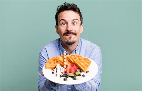 Premium Photo Adult Man Having Waffles For Breakfast