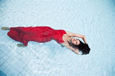 Woman In A Red Dress Swimming In The Pool Stock Photo Image Of Dive