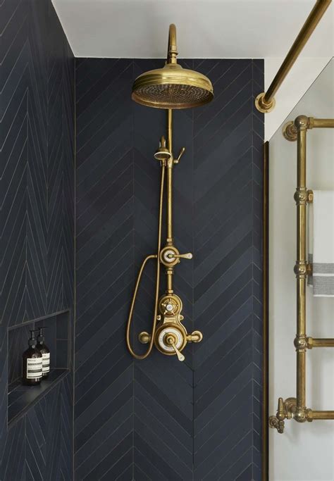 moody shower with black tile and brass plumbing fixtures stylish bathroom bathroom decor