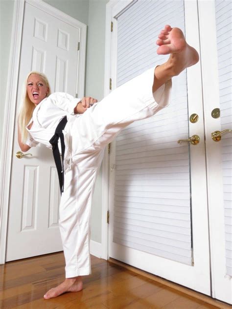 the woman is practicing karate moves in her home