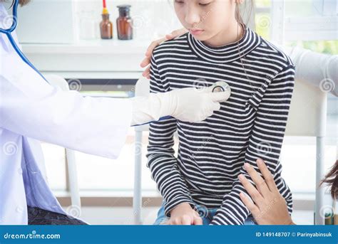 Doctor Examining A Girl By Stethoscope At Hospital Stock Image Image