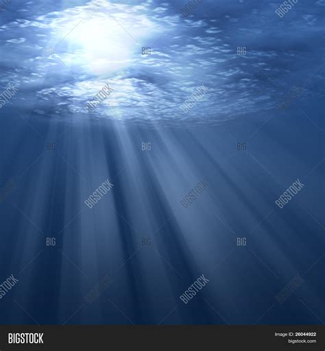 Underwater Scene With Sun Rays Shining Through Water Surface Image
