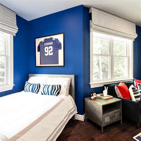The look perfectly balances warm and cool notes. Blue Kid's Bedroom With Jersey | Blue bedroom walls, Royal ...