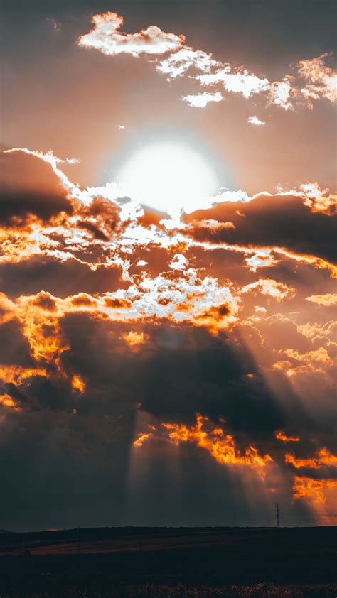 Download Wallpaper 1080x1920 Clouds Sun Sunset Overcast