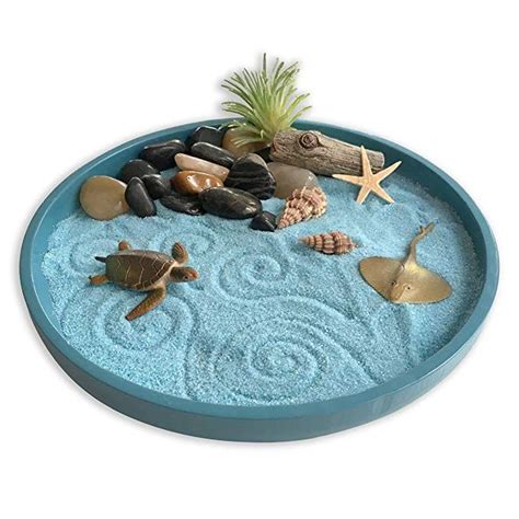 A Blue Bowl Filled With Sand And Sea Shells