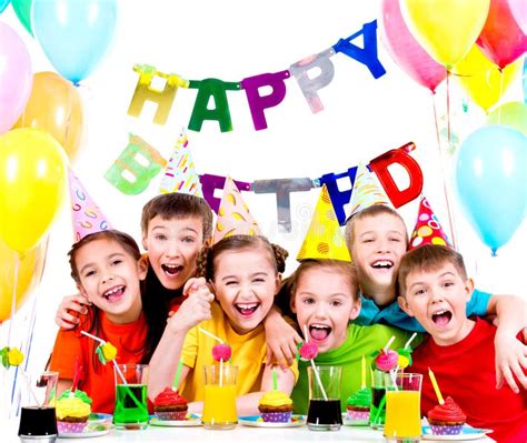Group Of Laughing Kids Having Fun At The Birthday Party Stock Photo