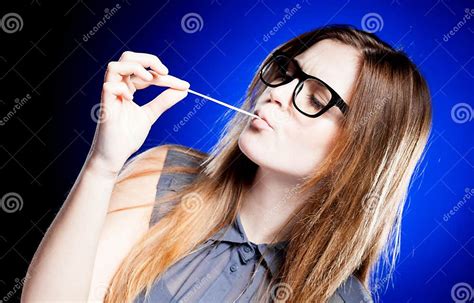 Portrait Of Strict Young Woman With Nerd Glasses And Chewing Gum Stock