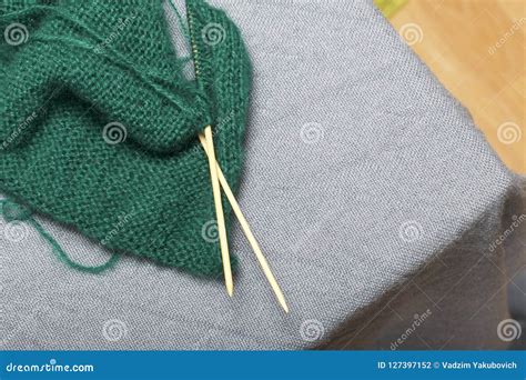 Knitting With Wooden Knitting A Ball Of Dark Green Thread And Wooden