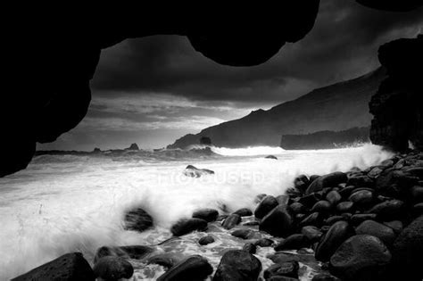 Picturesque View Of Rock Coast Near Water Surface And Wonderful Heaven