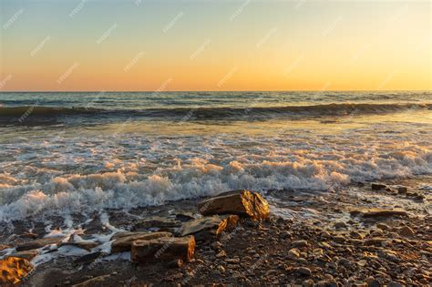 Premium Photo Dark Blue Waves Against The Beautiful Orange Sunset At