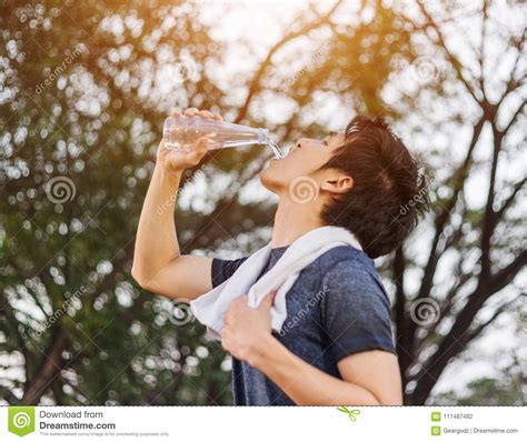 Young Sporty Man Drinking Water In Park Stock Photo Image Of Blue
