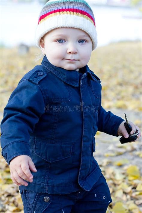 Little Baby Boy Walking Away In Colorful Autumn Park Stock Image