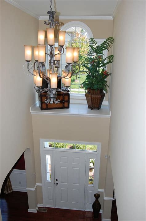 Two Story Foyer With Shelf Above Door With Window What