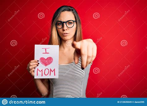 Young Beautiful Woman Holding Paper With Love Mom Message Celebrating Mothers Day Pointing With