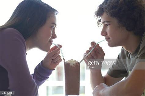 Teenage Couple Sharing Milkshake Photos And Premium High Res Pictures