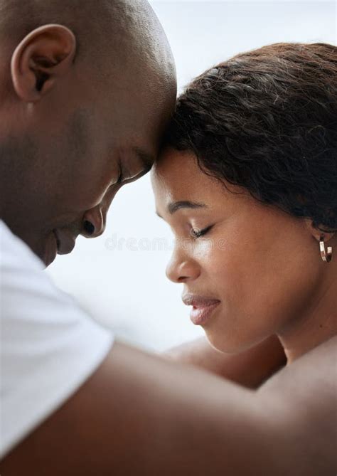 Closeup Of A Young African American Married Couple Standing Face To Face With Their Foreheads