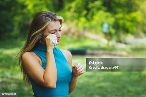 Woman Rubbing Her Eye Outdoors Stock Photo Download Image Now 20 24