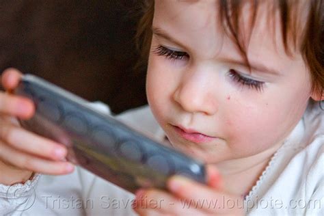 Kid Playing Game On Iphone