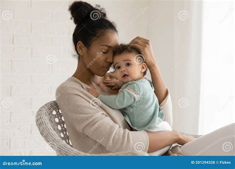 Happy African American Mom Embrace Newborn Baby Daughter Stock Photo