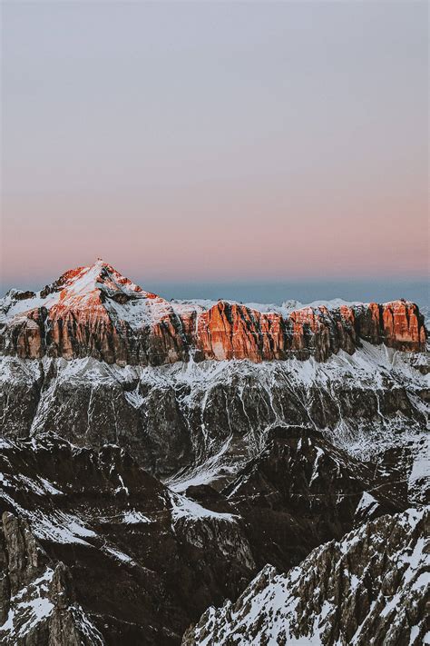 Download Dusk Over The Snowy Mountain Landscape On Iphone Wallpaper