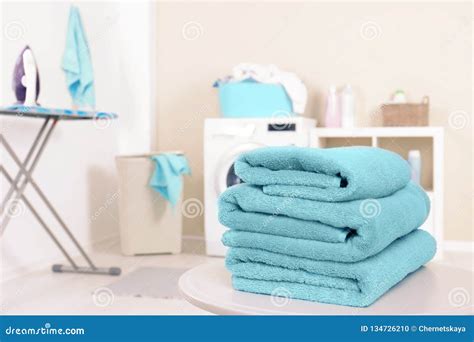 Stack Of Clean Towels On Table In Laundry Room Stock Photo Image Of