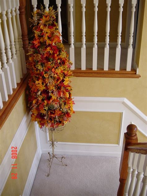 A Fall Tree Made From A Tomato Cage Atop A Painted Plant Stand Cover
