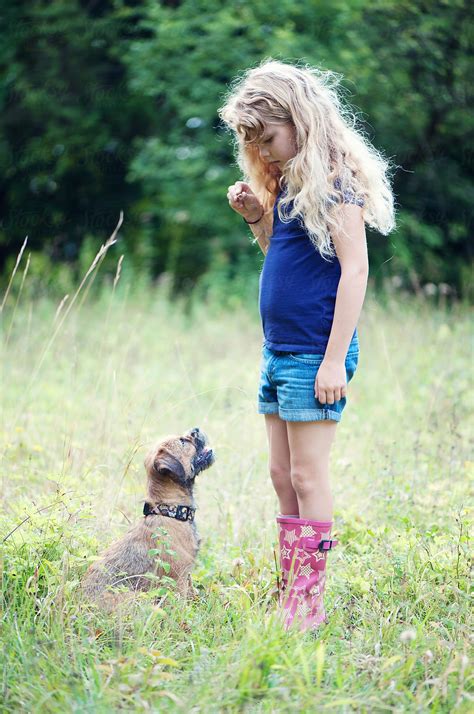 Young Girl Standing With Her Border Terrier By Stocksy Contributor