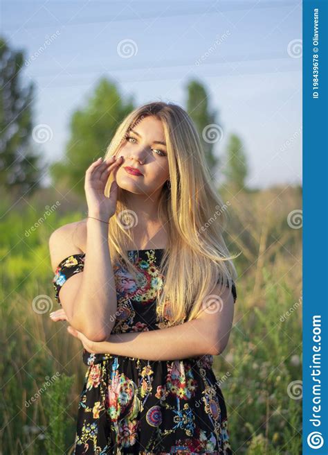 Overlight Bright Portrait Of A Charming Attractive Blonde In Flowery