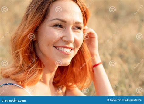 tender beautiful red haired girl enjoys the sunset in a field with a hill stock image image of