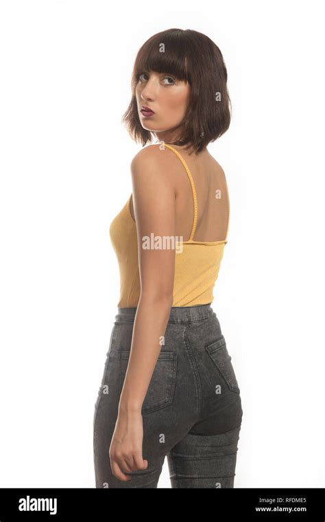 Rear View Of A Beautiful Young Woman Looking Over Shoulder Stock Photo