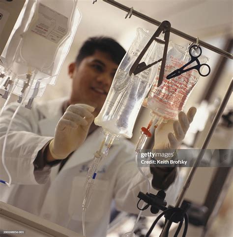 Doctor Adjusting Intravenous Drips High Res Stock Photo Getty Images