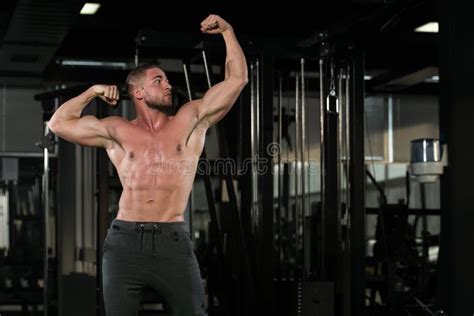 Young Bodybuilder Flexing Muscles Stock Photo Image Of Build