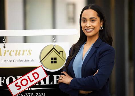 Cropped Portrait Of An Attractive Young Real Estate Agent Standing With Her Arms Crossed Next To