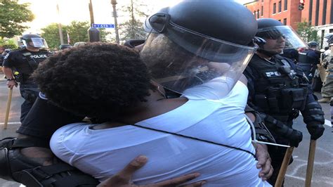 Louisville Officer And Woman Share Hug During Protest