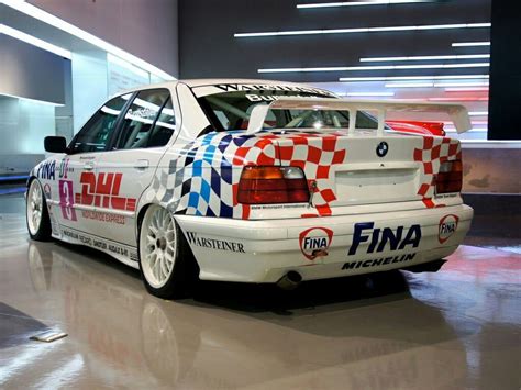 A White Car With Checkered Paint Parked In A Garage