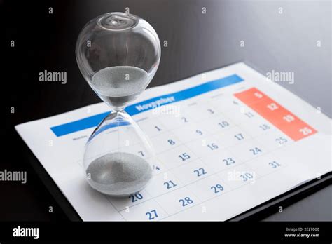 Time Passing Concept Time Slipping Away Hourglass And The Calendar