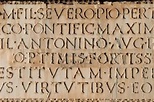 Close up of ancient Roman Latin Inscription in stone background ...