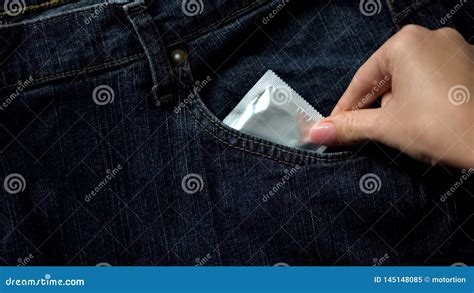 Female Putting Condom In Jeans Pocket Aids And Venereal Disease Prevention Stock Image Image