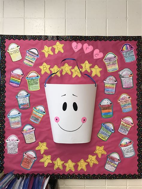 A Bulletin Board With A Bucket On Top Of It And Stars Around The Bottom