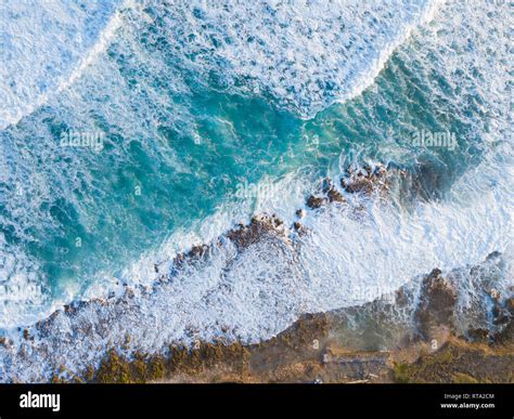 Aerial Drone Shot Showing The Ocean And Wave Breaks On The Rocky