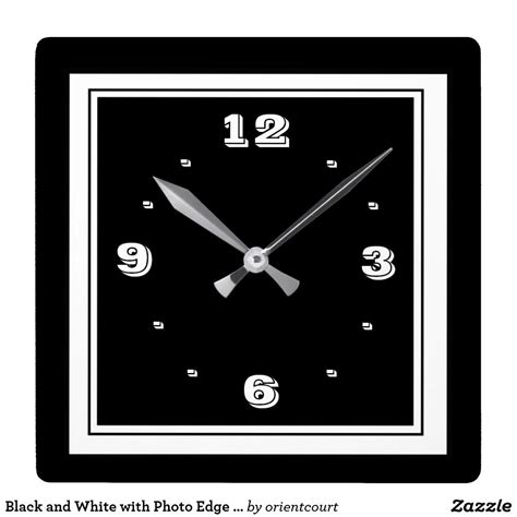 A Black And White Square Clock With The Numbers Twelve Nine On Its Face